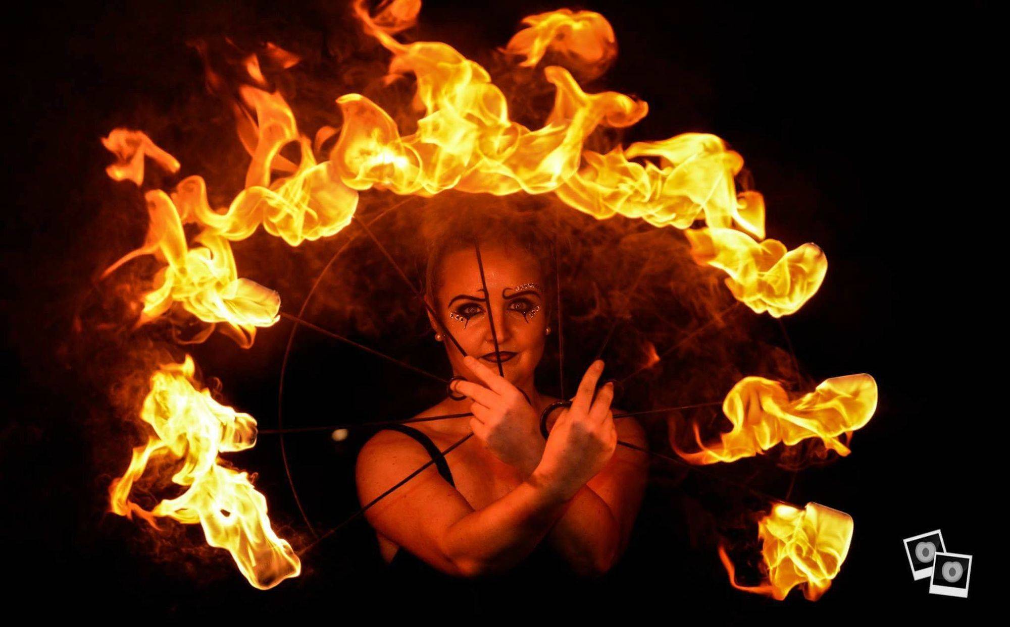 fire performer with fan prop